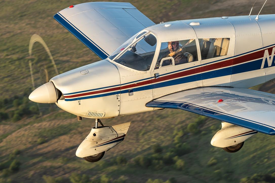 Close detail of N8513W, a Piper Cherokee 235, in flight